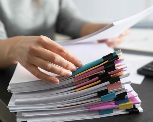 Office employee working with documents at table, closeup Office employee working with documents at table, closeup